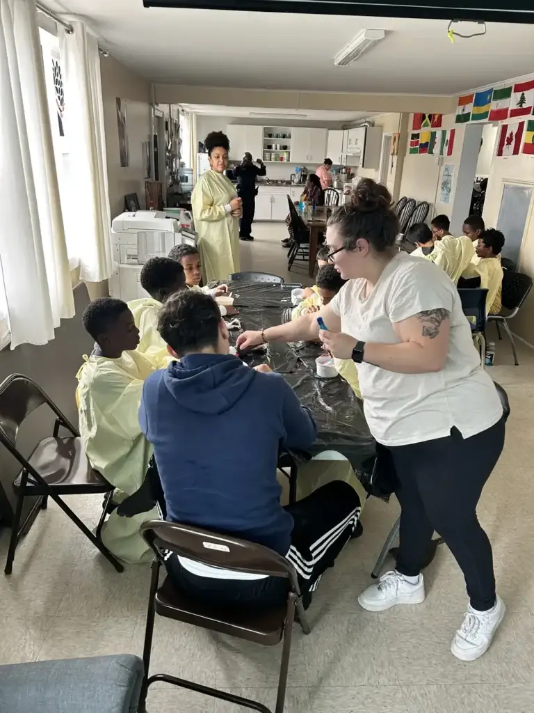 Kids participating in an activity on the table at the Mulgrave Park Caring and Learning Centre during the march break program