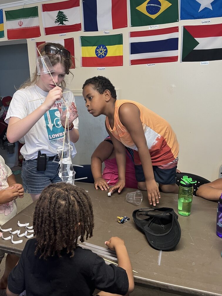 Kids participating in an activity on the table at the Mulgrave Park Caring and Learning Centre during the summer day camp